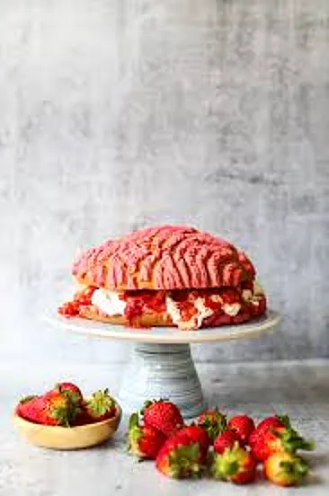 Strawberry concha layer cake decorated with fresh strawberries and signature conchas by Concha Choncha Panadería